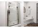Serene bathroom with a glass-enclosed shower, a soaking tub, and clean, white fixtures, designed for relaxation at 46 S Great White Way, Clayton, NC 27527