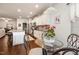 Stylish kitchen nook with glass table, leading into a chef's kitchen with modern stainless steel appliances at 46 S Great White Way, Clayton, NC 27527