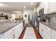 Well-lit kitchen featuring granite countertops, stainless steel appliances, and modern white cabinets at 46 S Great White Way, Clayton, NC 27527
