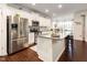 Modern kitchen with granite countertops, stainless steel appliances, and an open breakfast bar area for gatherings at 46 S Great White Way, Clayton, NC 27527