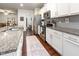 Bright kitchen with stainless steel appliances, granite countertops, and convenient access to the laundry area at 46 S Great White Way, Clayton, NC 27527