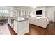 Open concept kitchen with granite countertops and stainless steel appliances overlooks the living room at 46 S Great White Way, Clayton, NC 27527