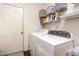 Functional laundry room with washer, dryer, and ample storage shelving at 46 S Great White Way, Clayton, NC 27527