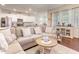 Spacious living room with hardwood floors, a comfortable sectional sofa, and an open view to a modern kitchen at 46 S Great White Way, Clayton, NC 27527