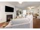 Cozy living room with fireplace, ceiling fans, and an adjacent dining area at 46 S Great White Way, Clayton, NC 27527