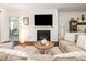 Inviting living room featuring a fireplace, large TV, and comfortable seating, next to an open bedroom area at 46 S Great White Way, Clayton, NC 27527