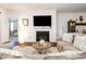 Comfortable living room features fireplace, large TV, and cozy seating, adjacent to an open bedroom area at 46 S Great White Way, Clayton, NC 27527