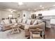 Inviting living room with an open floor plan, a large sectional sofa, and a view into the modern kitchen at 46 S Great White Way, Clayton, NC 27527