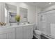 Bathroom featuring double sinks, mirrors, and a glass-enclosed shower at 473 Lavatera Dr, Wendell, NC 27591