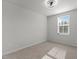 This bedroom offers neutral carpet and paint, a ceiling fan, and natural light from the window at 473 Lavatera Dr, Wendell, NC 27591