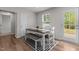Bright dining area features wood floors, modern decor, and a window for natural light at 473 Lavatera Dr, Wendell, NC 27591