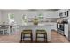 Charming kitchen featuring an island with bar stools, stainless appliances, and ample counter space at 473 Lavatera Dr, Wendell, NC 27591