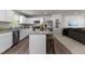 Open kitchen features stainless appliances, granite countertops, an island with breakfast bar, and ample cabinet space at 473 Lavatera Dr, Wendell, NC 27591