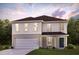 Charming two-story home with an attached garage and well-manicured lawn, blending comfort and curb appeal seamlessly at 5015 Harrier Ln, Snow Camp, NC 27349