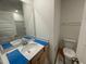 Bright bathroom with vanity, sink, large mirror and toilet at 503 Eastwood St, Durham, NC 27703