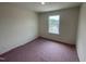 Carpeted bedroom with window providing natural light and exterior views at 503 Eastwood St, Durham, NC 27703