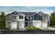 Row of townhomes featuring varied color schemes, single garages, and manicured lawns at 503 Eastwood St, Durham, NC 27703