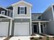 Charming two-story townhouse featuring a one-car garage and neat landscaping under a clear sky at 503 Eastwood St, Durham, NC 27703