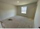 Bright bedroom featuring a window with natural light ready for new flooring at 505 Eastwood St, Durham, NC 27704
