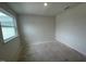 Bright bedroom featuring a large window, white walls, and an electrical outlet, ready for personalization at 505 Eastwood St, Durham, NC 27704