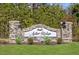 Stone entrance sign for Aster Ridge, surrounded by manicured landscaping and lush greenery at 505 Eastwood St, Durham, NC 27704