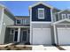 Charming townhome featuring a one-car garage, gray siding, and a classic design with a dark blue accent section at 505 Eastwood St, Durham, NC 27704