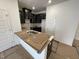 Well-lit kitchen with stainless steel sink, dark cabinets with subway tile backsplash, and a breakfast bar at 505 Eastwood St, Durham, NC 27704