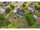 Aerial view displays the back of the house with patio, large lawn and trees at 5209 Thistleby Rd, Fuquay Varina, NC 27526