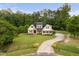 Stunning home with meticulous landscaping, a long driveway, and surrounded by mature trees at 5209 Thistleby Rd, Fuquay Varina, NC 27526
