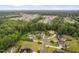 Aerial view showcasing a neighborhood's tree-lined streets, varied home styles, and community layout at 5209 Thistleby Rd, Fuquay Varina, NC 27526