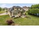 Aerial view of the home's backyard, including a patio with a fire pit and dining area at 5209 Thistleby Rd, Fuquay Varina, NC 27526
