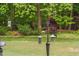 The backyard features a bird-feeding station and is surrounded by trees and a grassy lawn at 5209 Thistleby Rd, Fuquay Varina, NC 27526