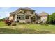 Expansive backyard featuring a patio area, lush lawn, and meticulously maintained landscaping at 5209 Thistleby Rd, Fuquay Varina, NC 27526
