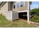 View of the home's basement access, enclosed by a white lattice fence and situated on a well-maintained lawn at 5209 Thistleby Rd, Fuquay Varina, NC 27526