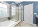 Bathroom featuring a tiled shower, garden tub, and large windows with natural light at 5209 Thistleby Rd, Fuquay Varina, NC 27526
