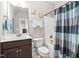 Bathroom featuring a single sink vanity, tub with shower, and neutral decor at 5209 Thistleby Rd, Fuquay Varina, NC 27526