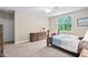 Bright bedroom featuring a simple bed, matching dressers, and a large window at 5209 Thistleby Rd, Fuquay Varina, NC 27526