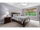 Cozy bedroom featuring a queen bed, a window with blinds, and traditional furnishings at 5209 Thistleby Rd, Fuquay Varina, NC 27526