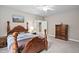 Bedroom with neutral walls and ceiling fan, features a four-poster bed and classic furnishings at 5209 Thistleby Rd, Fuquay Varina, NC 27526