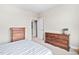 Neutral-toned bedroom featuring two dressers, soft carpet, and ample natural light at 5209 Thistleby Rd, Fuquay Varina, NC 27526