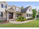 Inviting home with stone detailing, covered porch, and meticulously maintained landscaping at 5209 Thistleby Rd, Fuquay Varina, NC 27526