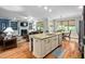 An open kitchen island with a sink, stainless steel dishwasher, and a dining area nearby at 5209 Thistleby Rd, Fuquay Varina, NC 27526