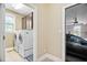 Spacious laundry room with cabinetry and a window, located between the garage and kitchen at 5209 Thistleby Rd, Fuquay Varina, NC 27526