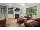 Living room area featuring a fireplace with built-ins, hardwood flooring, and neutral paint at 5209 Thistleby Rd, Fuquay Varina, NC 27526