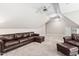Comfortable living room with vaulted ceilings and a plush leather sofa and armchair at 5209 Thistleby Rd, Fuquay Varina, NC 27526