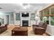Living room featuring a fireplace with built-ins, leather furniture, and natural light at 5209 Thistleby Rd, Fuquay Varina, NC 27526