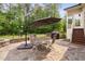 Charming stone patio with a dining set and grilling area at 5209 Thistleby Rd, Fuquay Varina, NC 27526