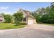 Home featuring a side-entry garage, well-maintained lawn, and mature landscaping at 5209 Thistleby Rd, Fuquay Varina, NC 27526