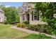 Home featuring lush landscaping and a charming pathway leading to the entrance at 5209 Thistleby Rd, Fuquay Varina, NC 27526