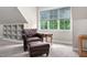 Bright sitting area featuring built-in shelves, a comfortable chair, and a window with natural light at 5209 Thistleby Rd, Fuquay Varina, NC 27526